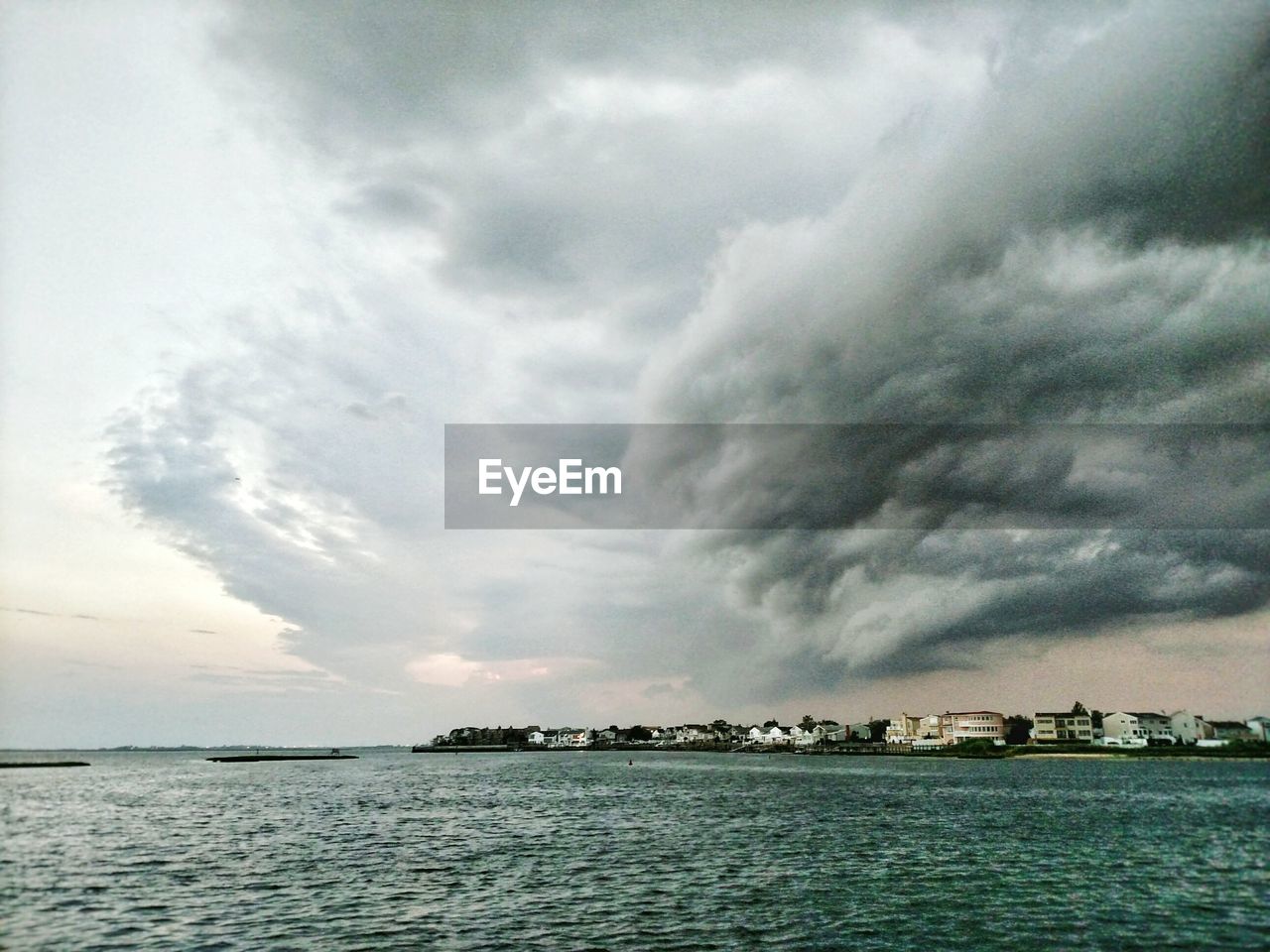 Scenic view of sea against cloudy sky