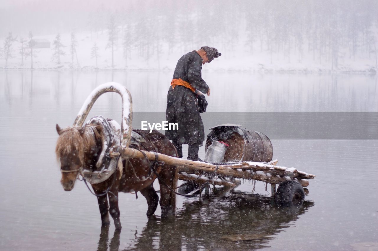 MAN WITH DOG IN SNOW