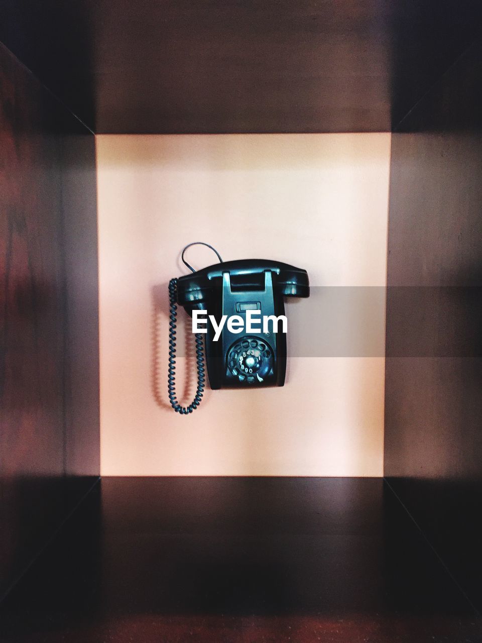 CLOSE-UP OF TELEPHONE BOOTH ON TABLE