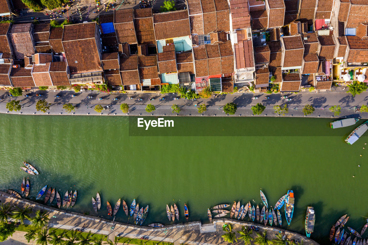 Drone view of river by buildings