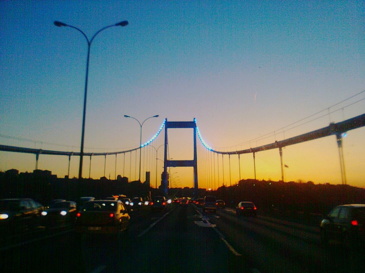 Traffic on road at sunset