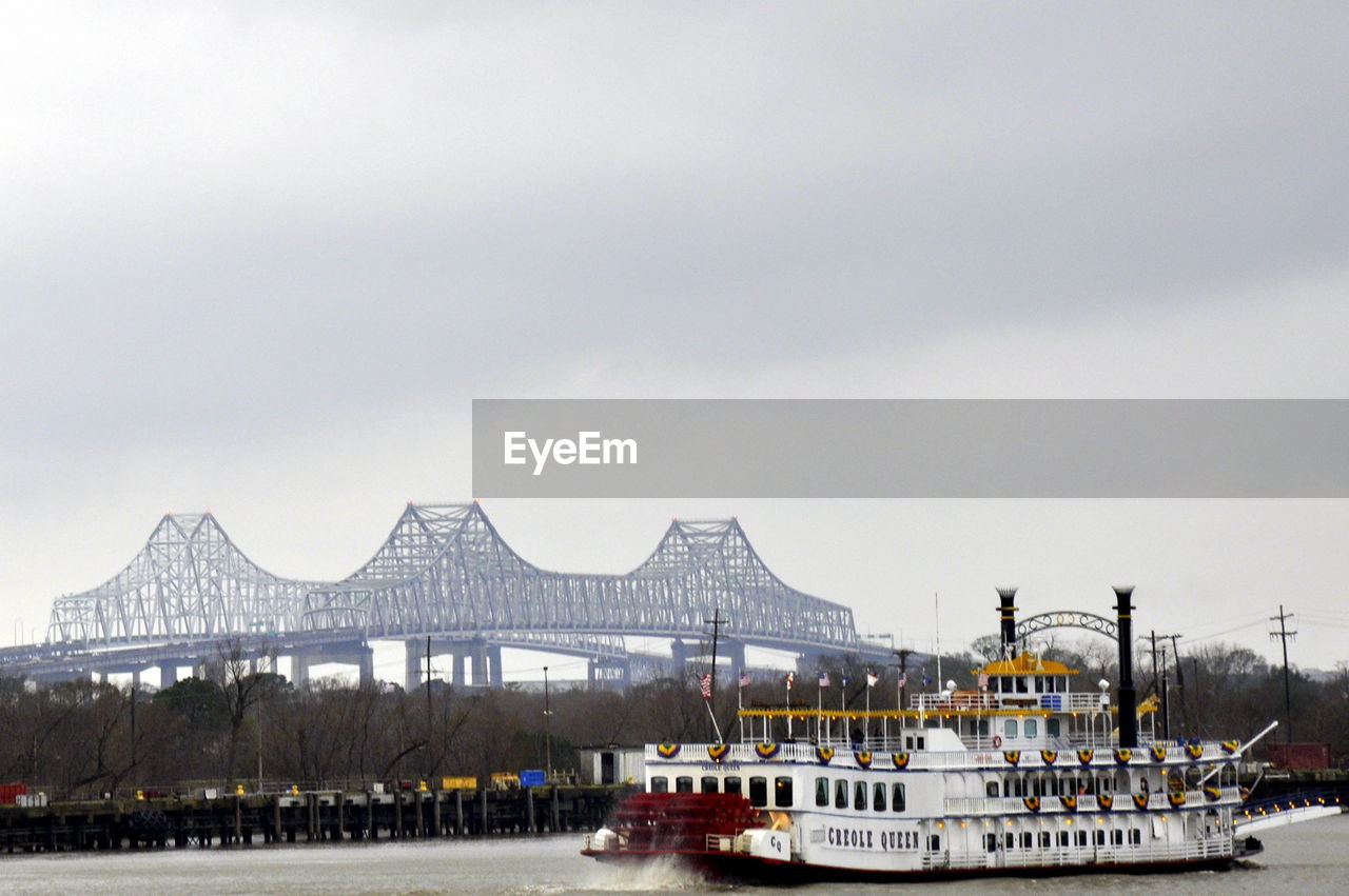 AMUSEMENT PARK BY BOAT AGAINST SKY