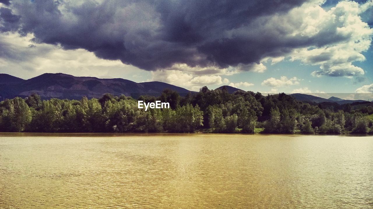 SCENIC VIEW OF MOUNTAINS AGAINST CLOUDY SKY