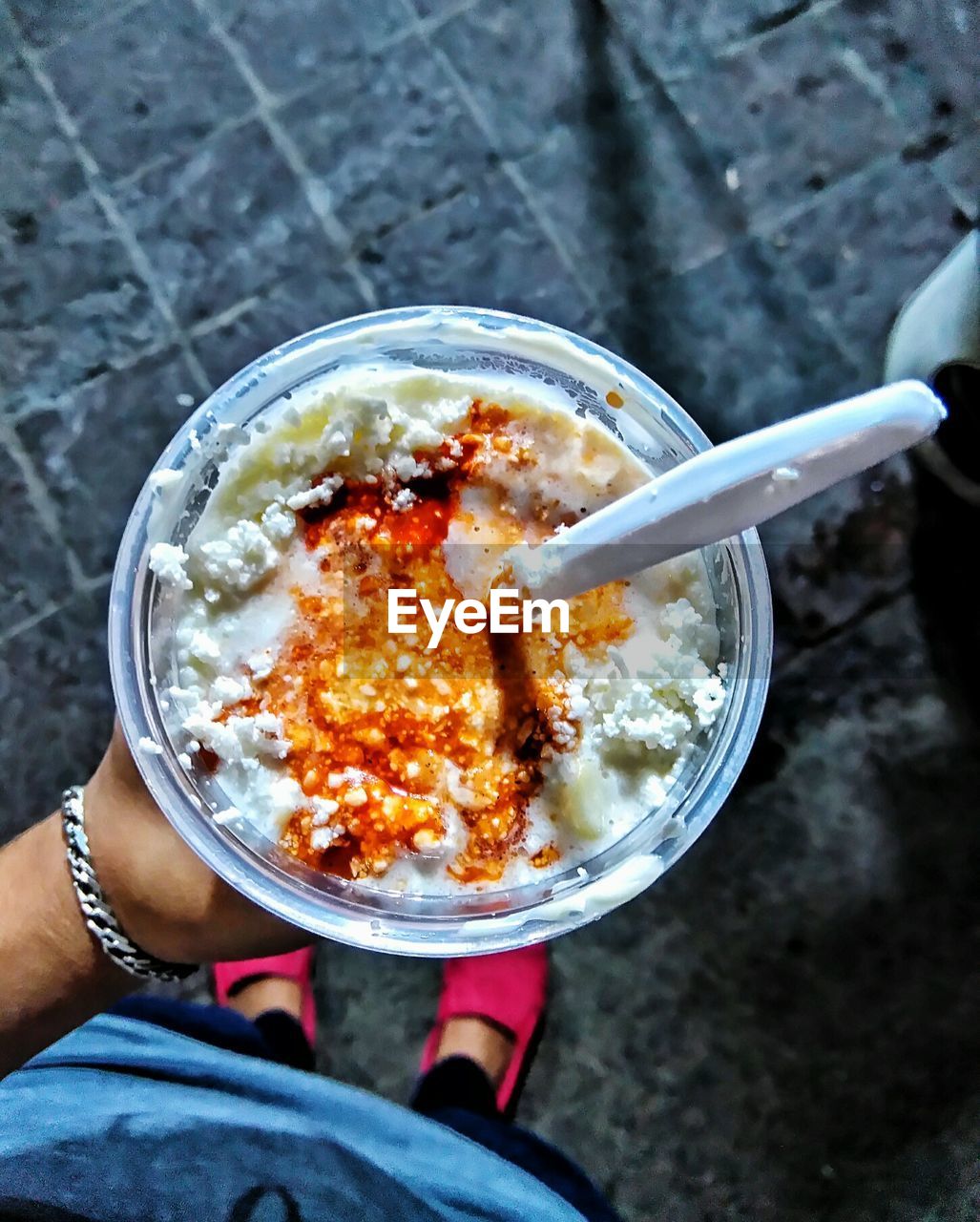 Low section of person standing while holding esquites