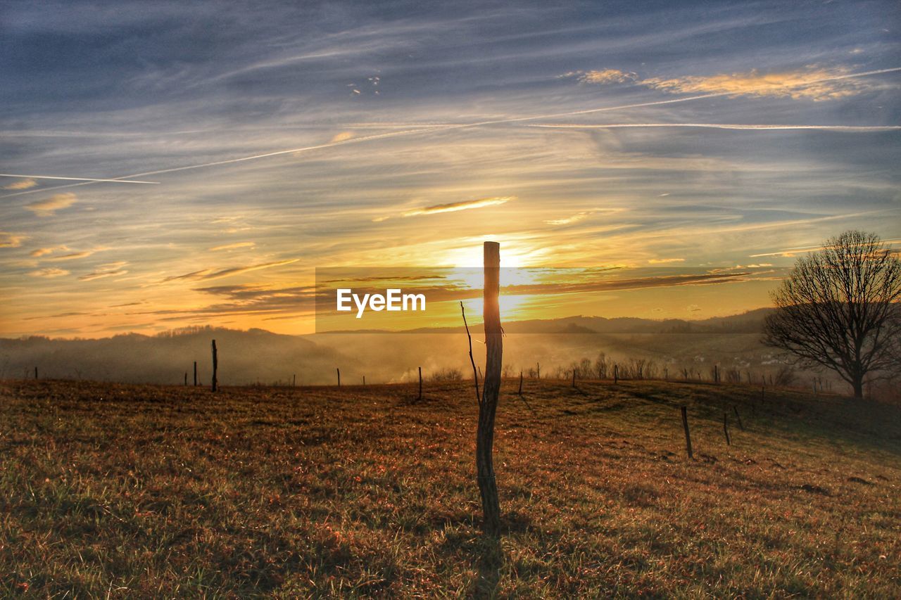 FIELD AGAINST SKY DURING SUNSET