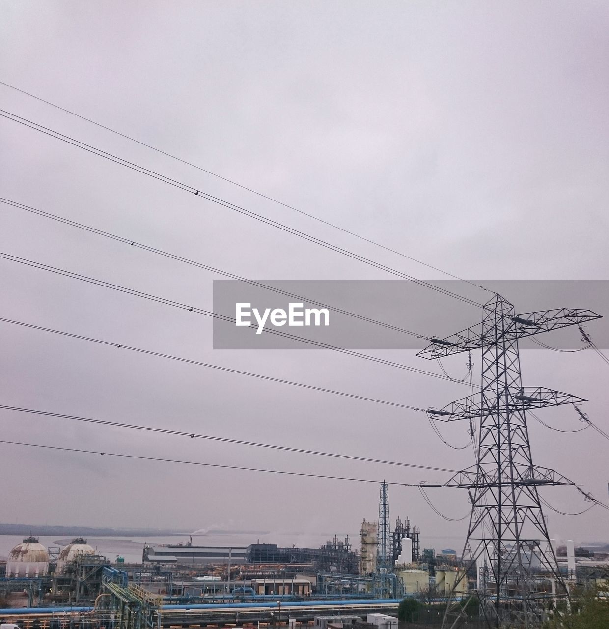 Silhouette of electric pylon against sky