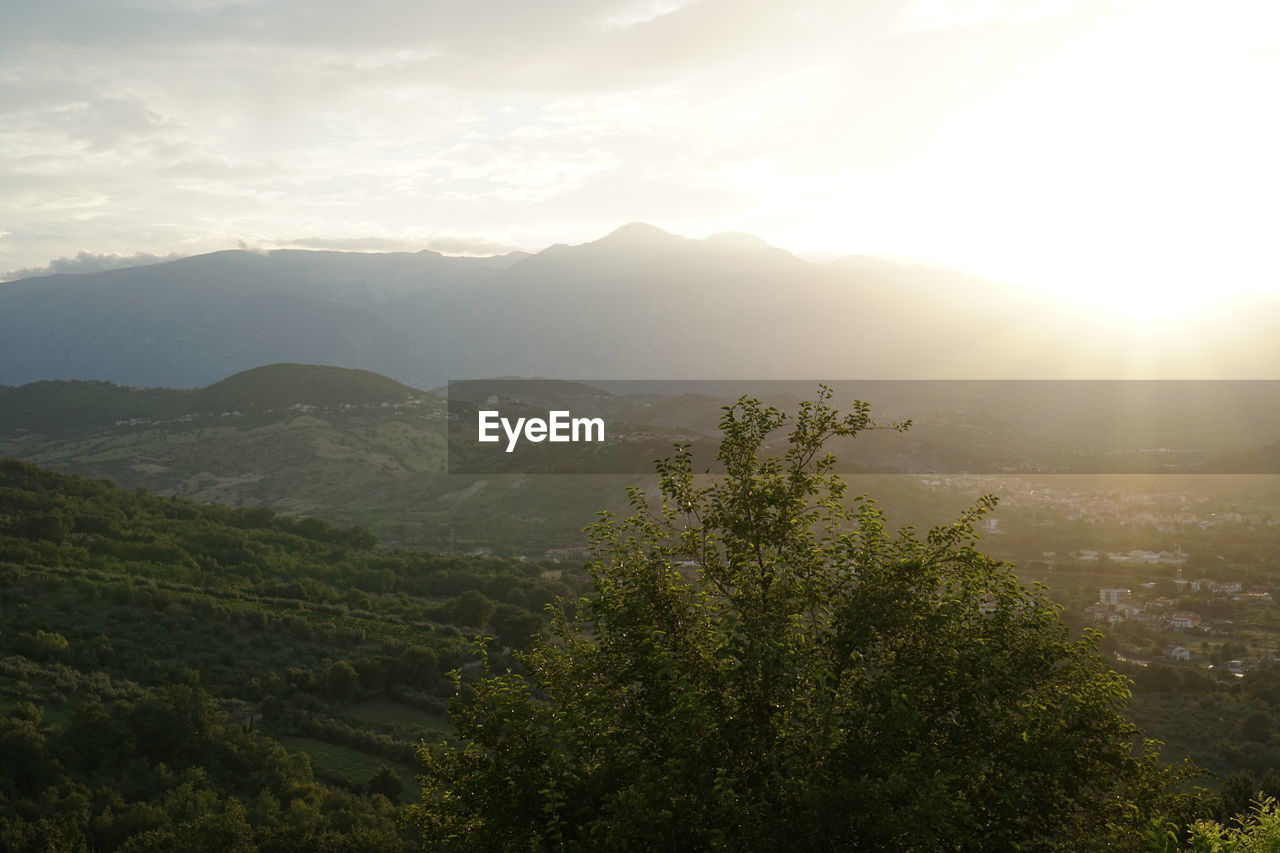 Scenic view of mountains against sky at sunset