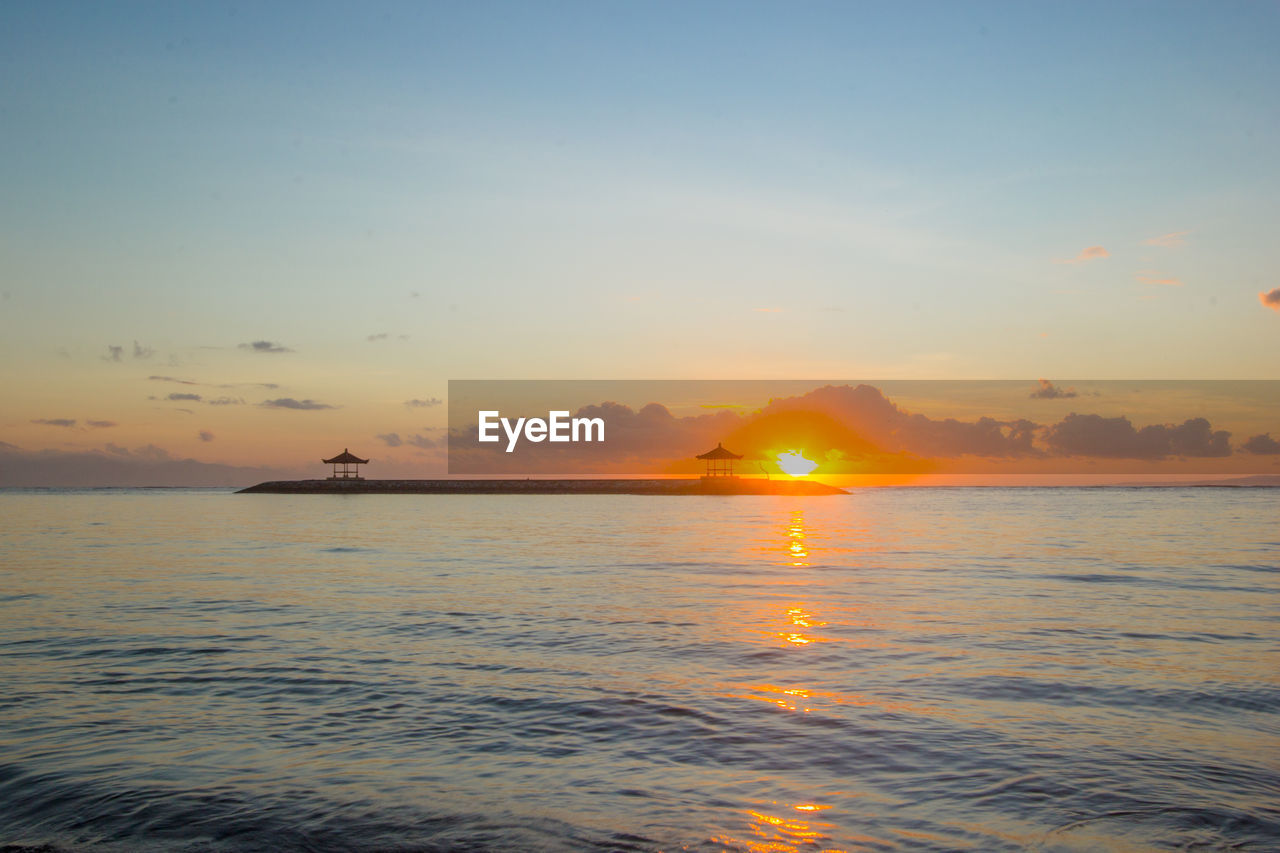 SCENIC VIEW OF SEA AGAINST ORANGE SKY