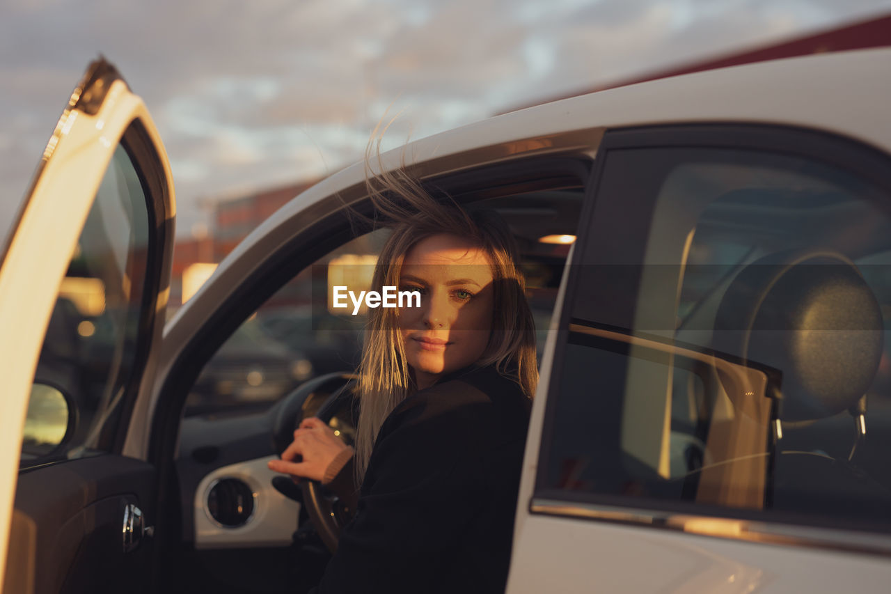 Portrait of young woman in car