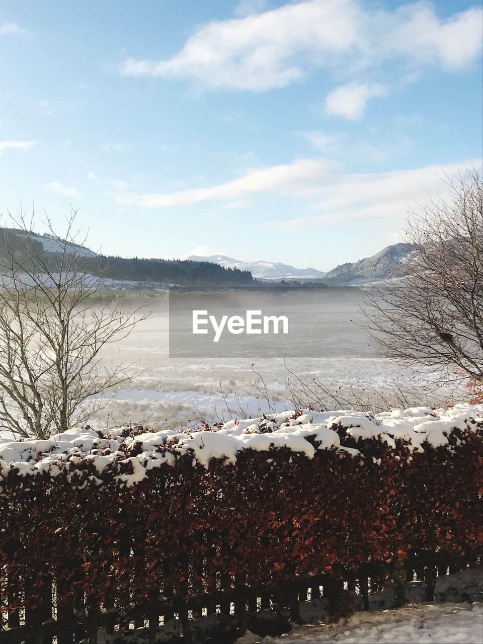 Scenic view of snow covered mountains against sky