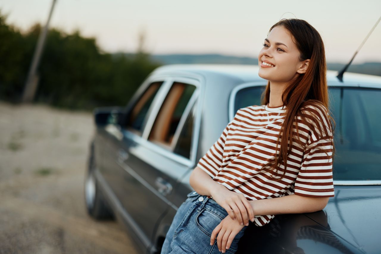 portrait of young woman sitting in car