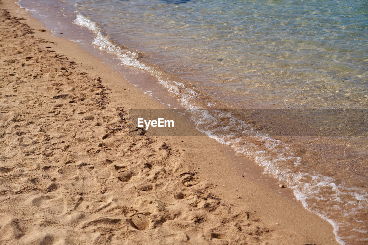 beach, land, sand, water, sea, nature, wave, high angle view, shore, day, no people, soil, body of water, tranquility, sports, water sports, beauty in nature, motion, footprint, outdoors, ocean, wind wave, sunlight, coast, scenics - nature, tranquil scene, wet