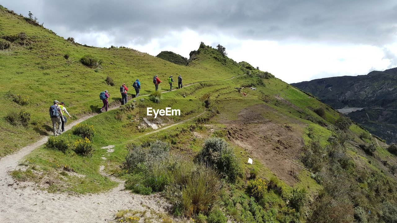 PANORAMIC VIEW OF PEOPLE WALKING ON MOUNTAIN