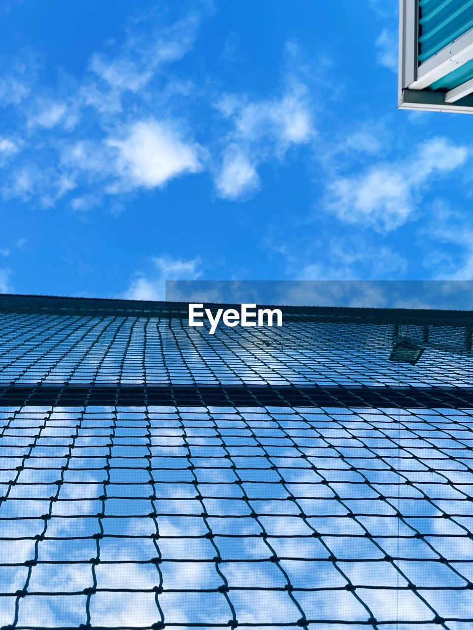 sky, blue, architecture, built structure, building exterior, cloud, daylighting, sunlight, solar energy, solar panel, facade, building, skyscraper, nature, city, technology, day, no people, low angle view, alternative energy, reflection, outdoors, renewable energy, roof, power generation, line, environmental conservation, business, solar power, pattern, glass
