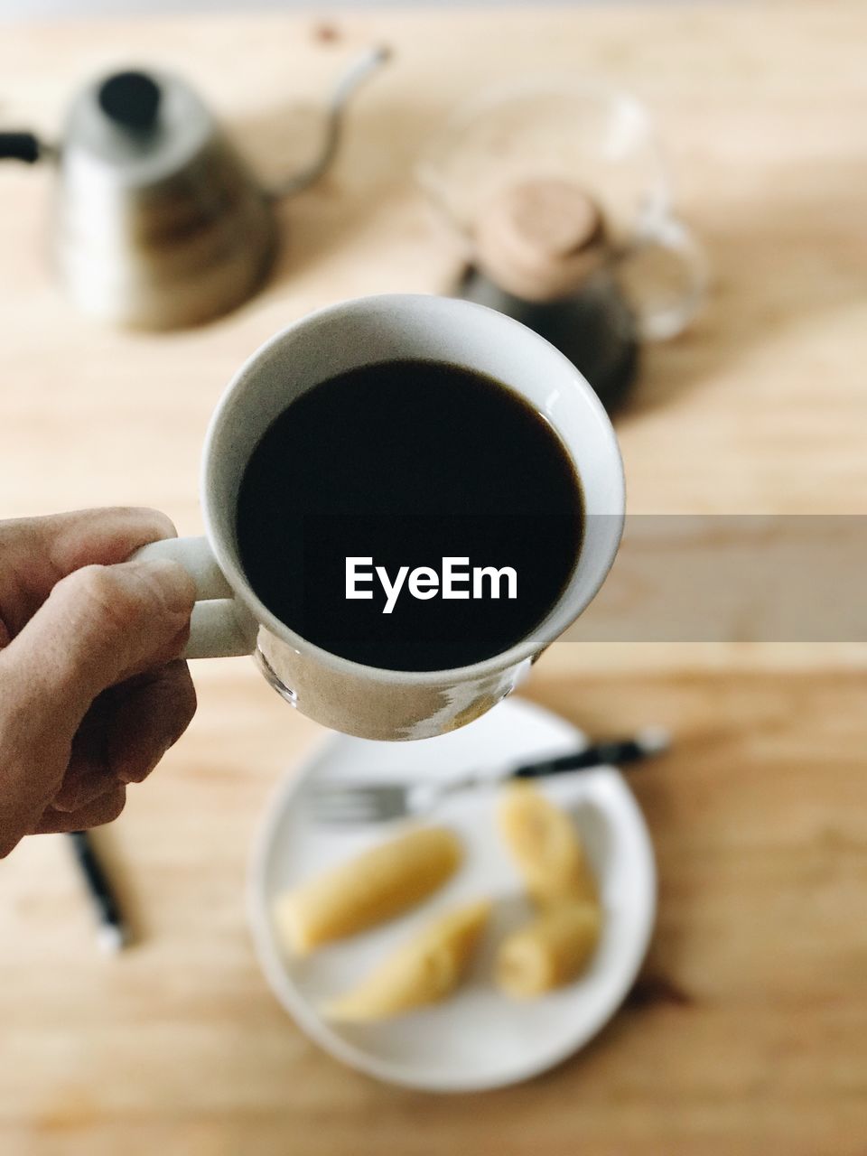 Close-up of hand holding coffee cup