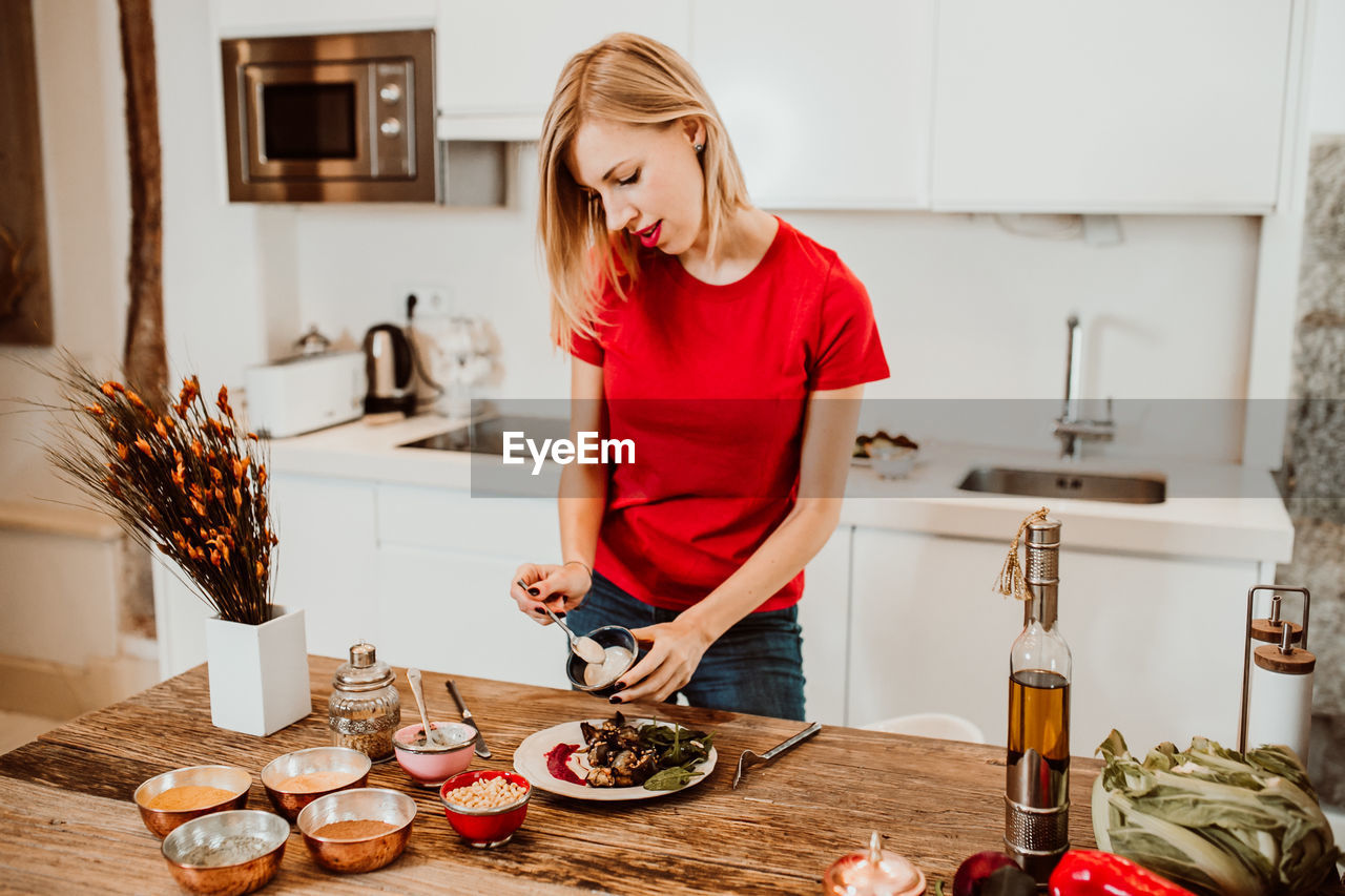 Woman preparing food in kitchen at home