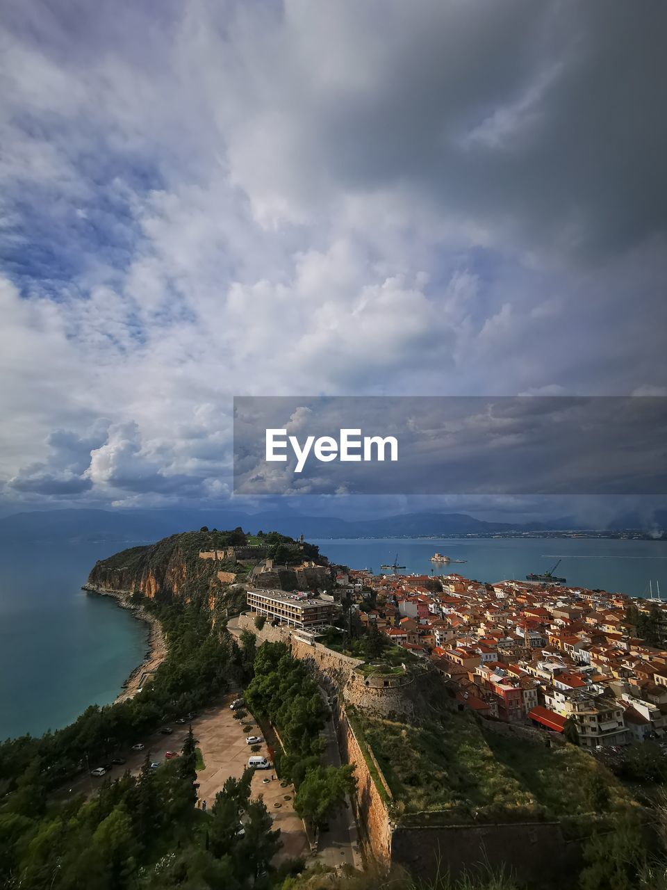 High angle view of townscape by sea against sky