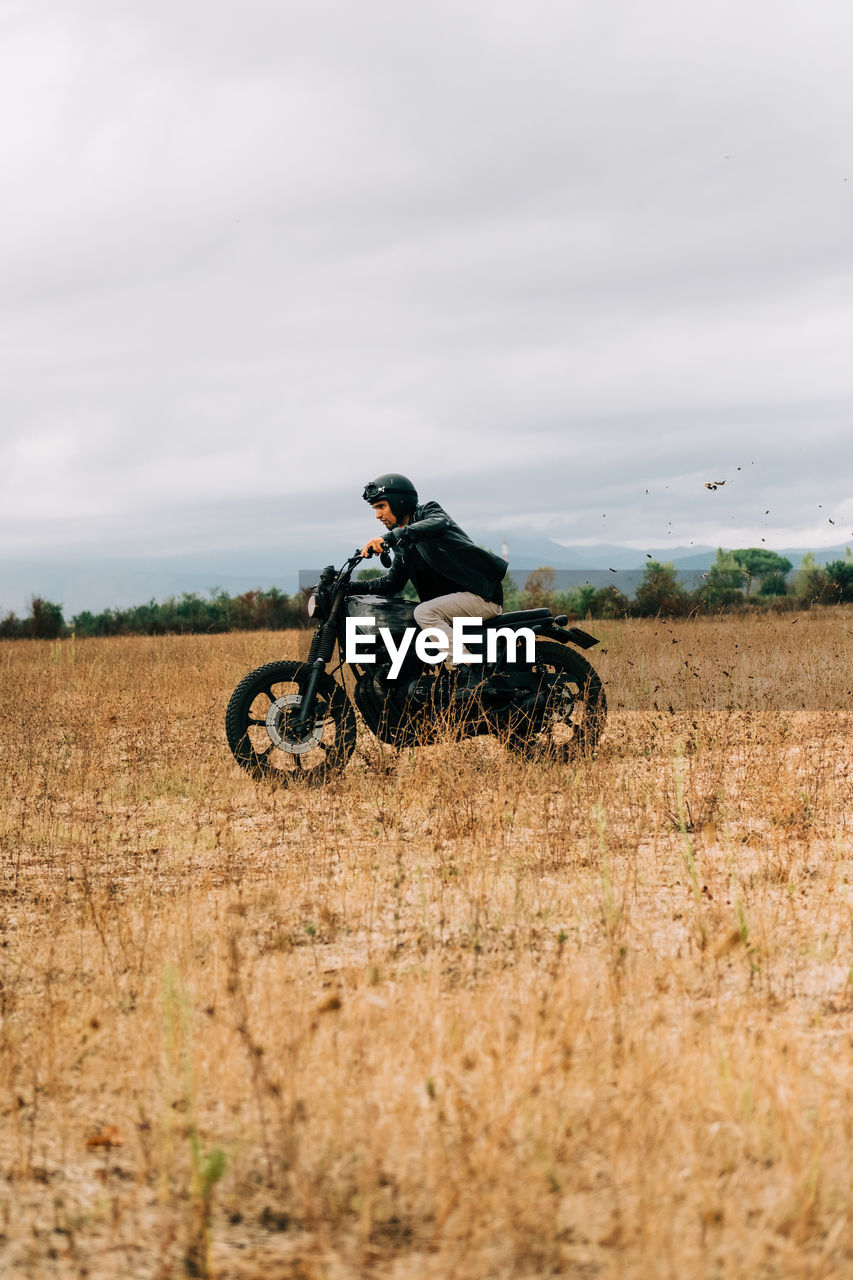 Men riding a motorbike in italy countryside