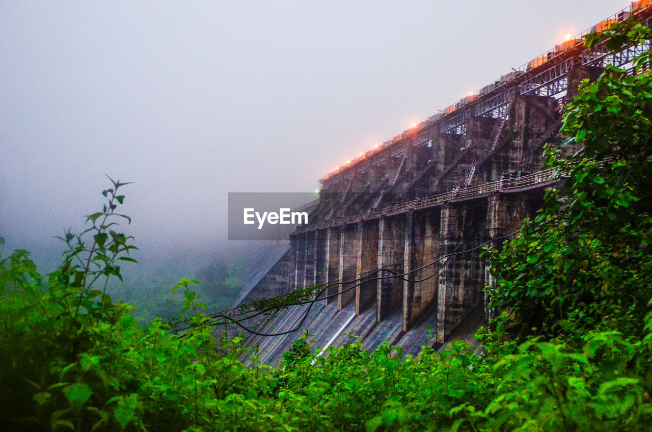 Scenic view of foggy weather against sky