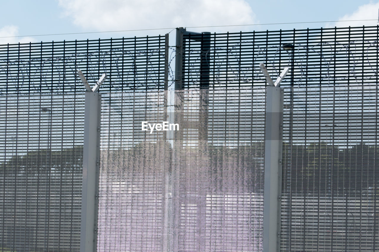 METAL GRATE AGAINST SKY