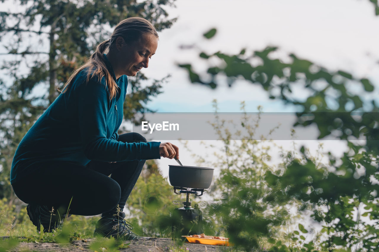 Woman cooking food on stove