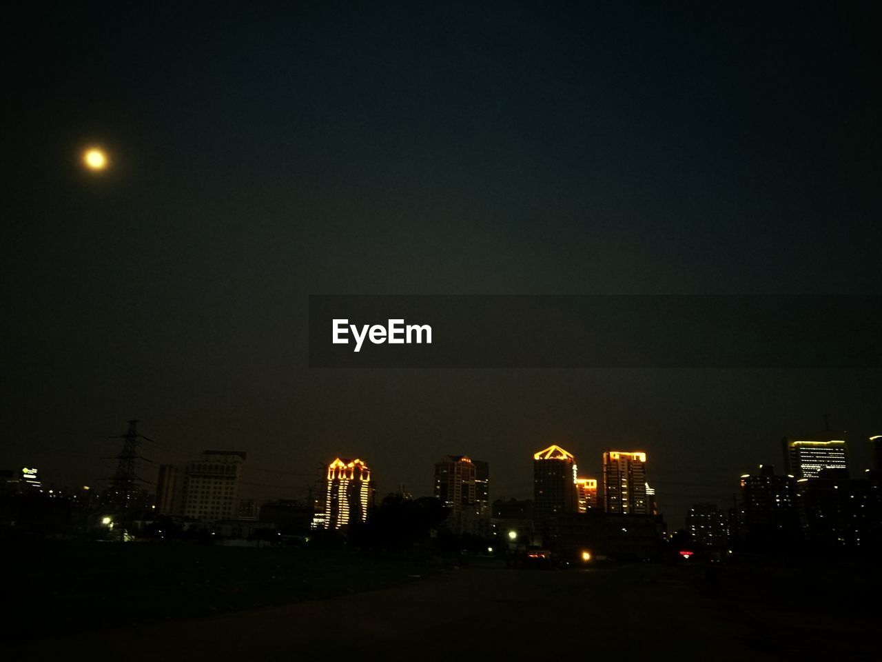 ILLUMINATED BUILDINGS IN CITY AT NIGHT