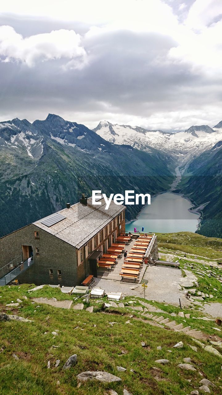 BUILT STRUCTURE ON SNOWCAPPED MOUNTAIN AGAINST SKY