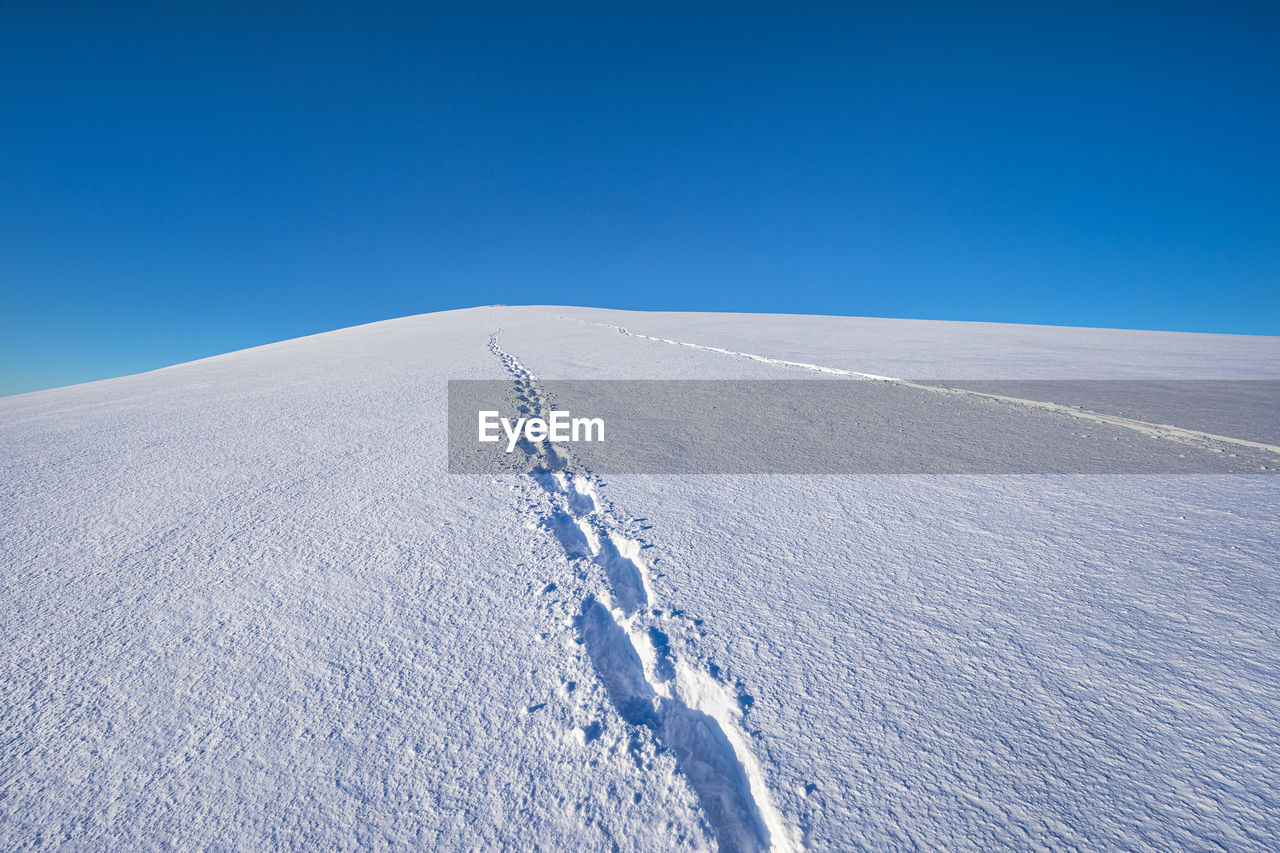 View of footprint on snow covered land