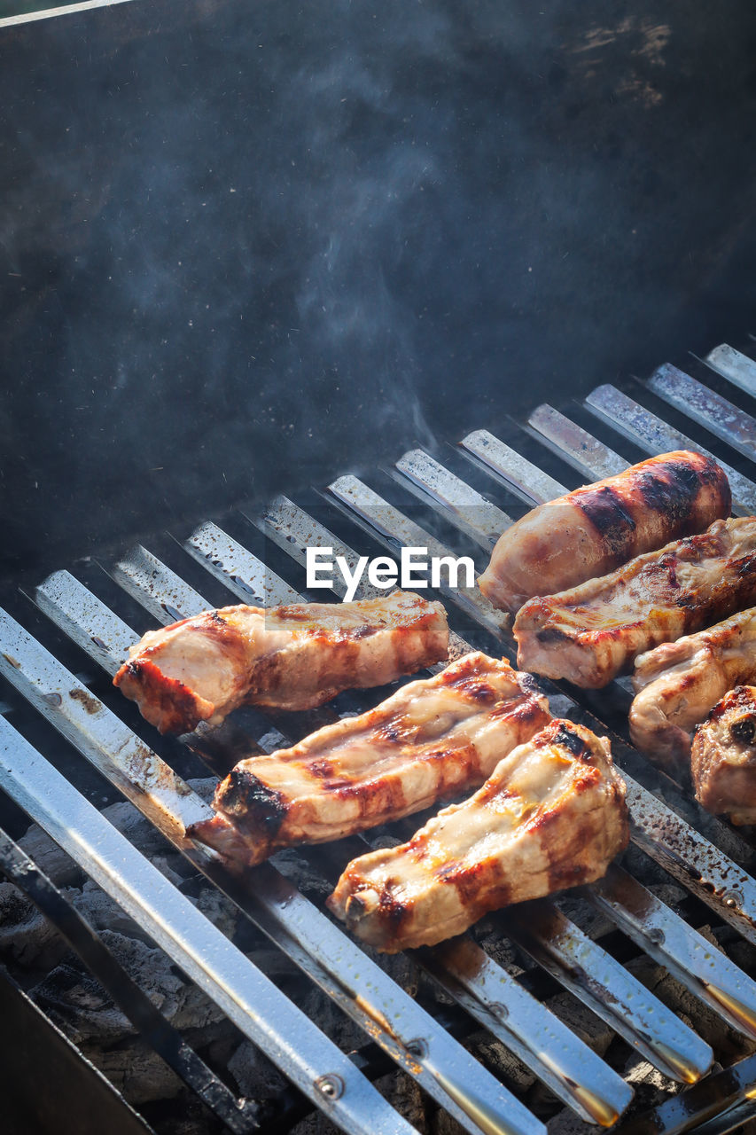 High angle view of meat on barbecue grill