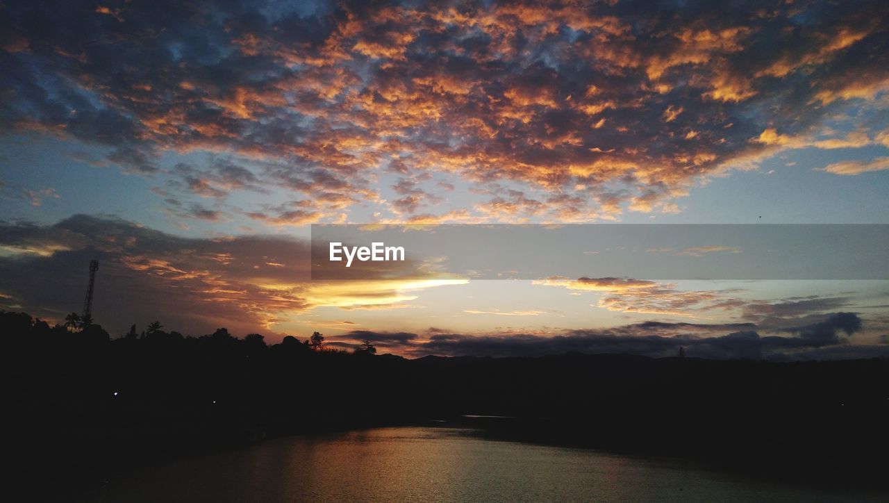 SCENIC VIEW OF SUNSET OVER LAKE