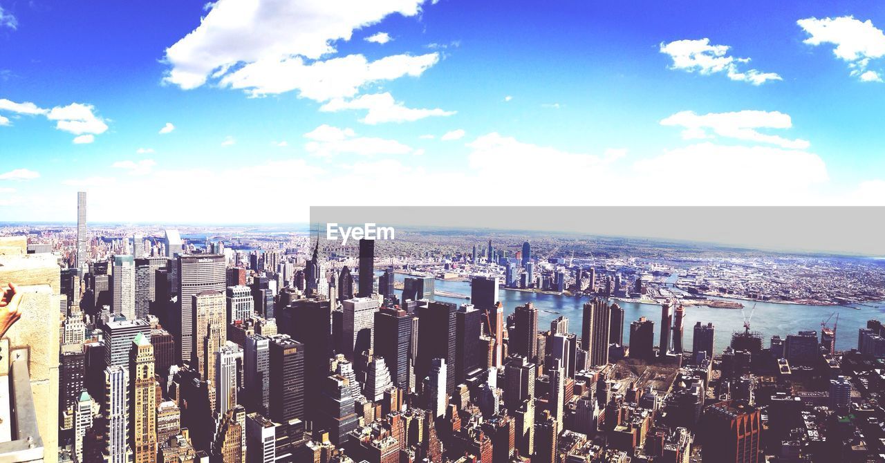 VIEW OF CITYSCAPE AGAINST CLOUDY SKY