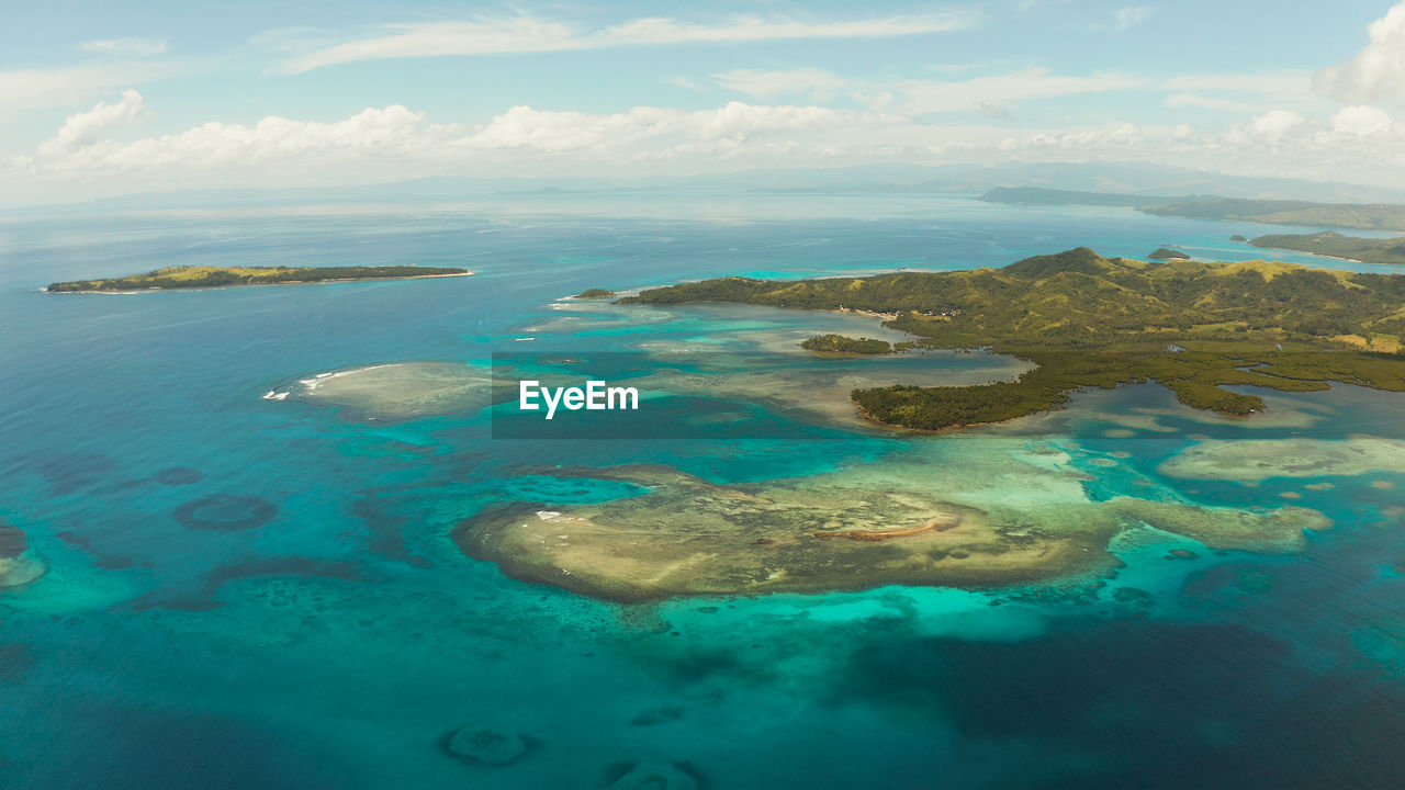 Tropical islands with beaches and azure coral reef water from above. bucas grande, philippines