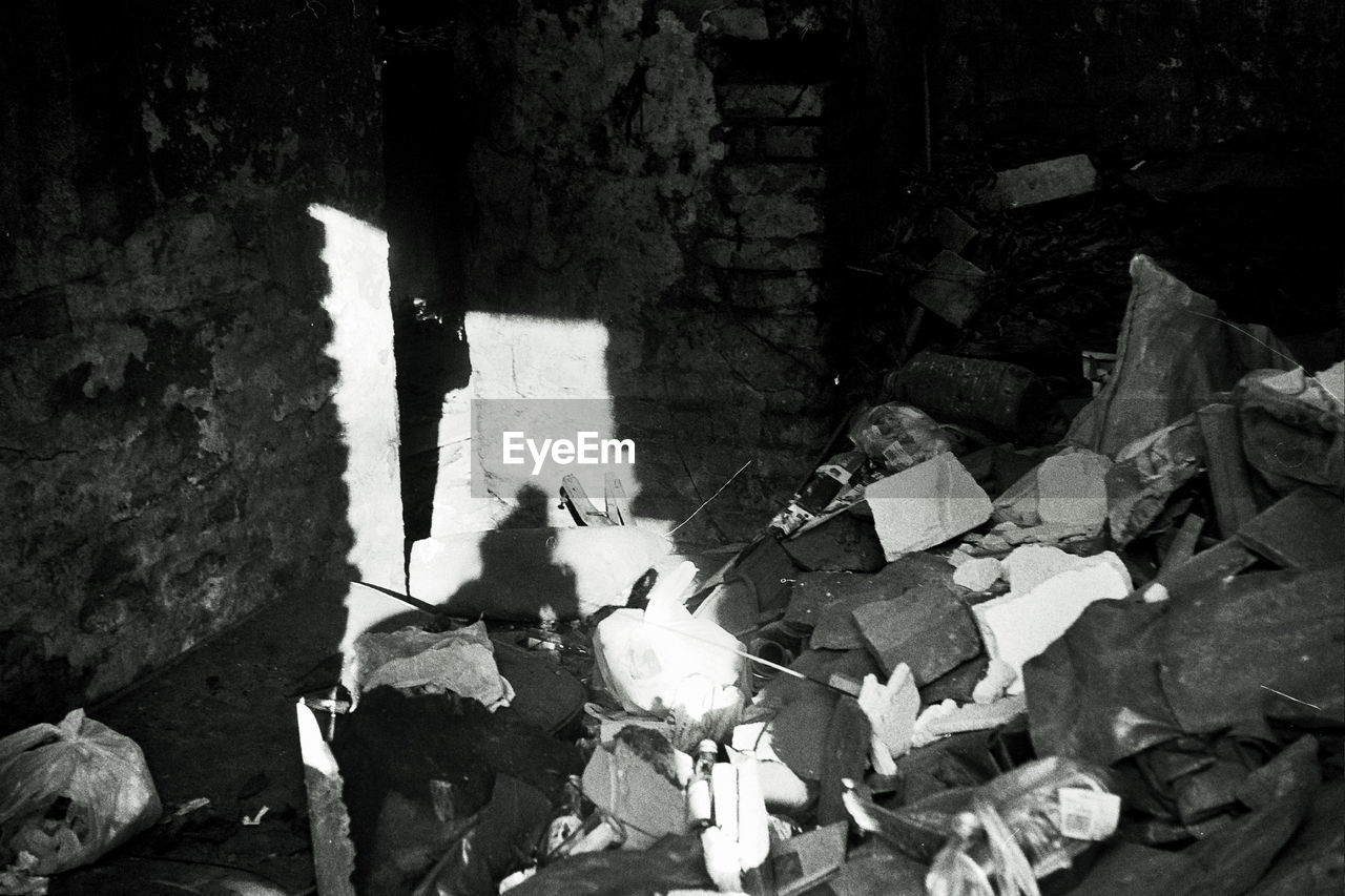 HIGH ANGLE VIEW OF SHADOW ON STONE WALL