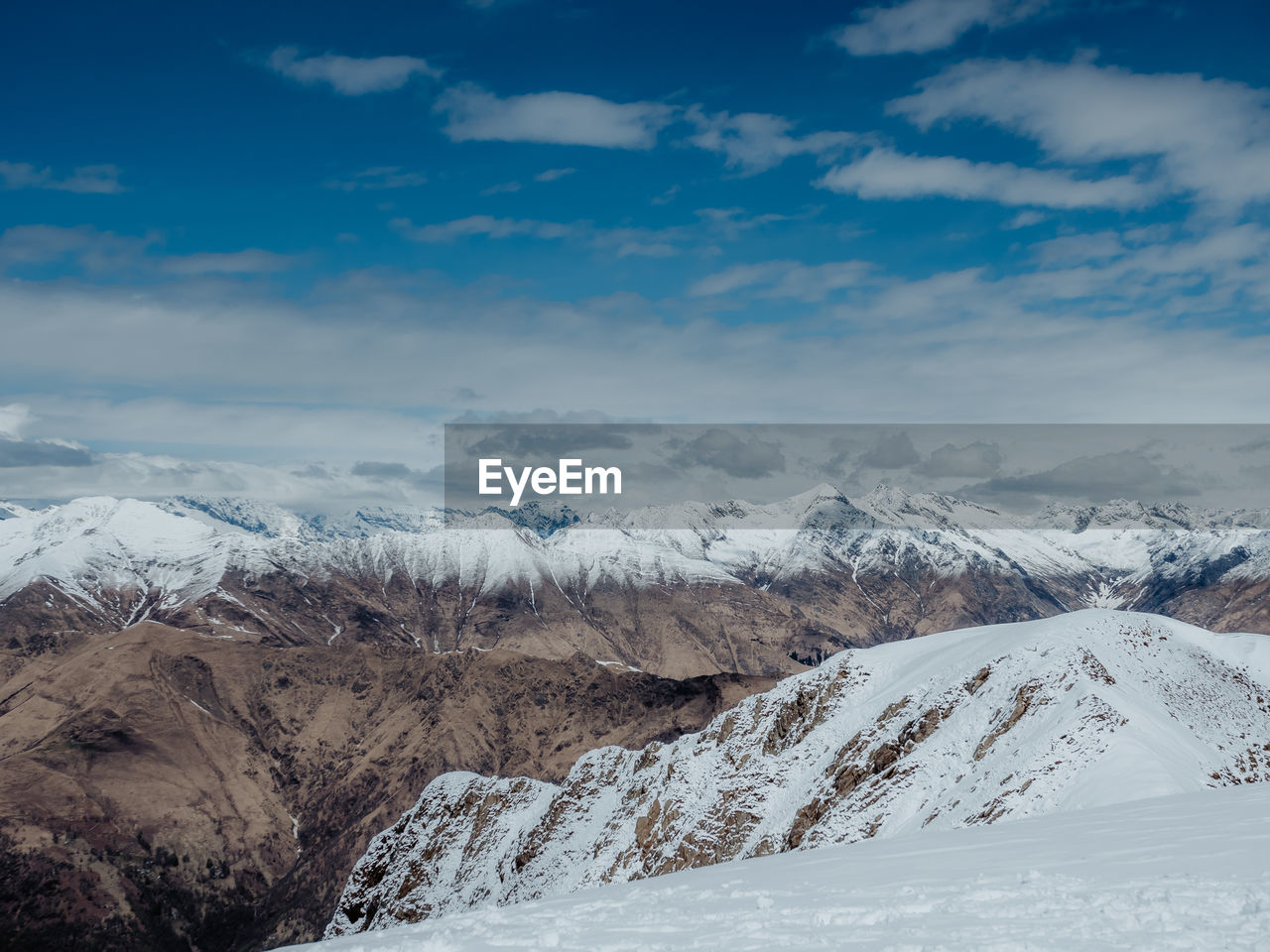 SNOW COVERED MOUNTAIN AGAINST SKY