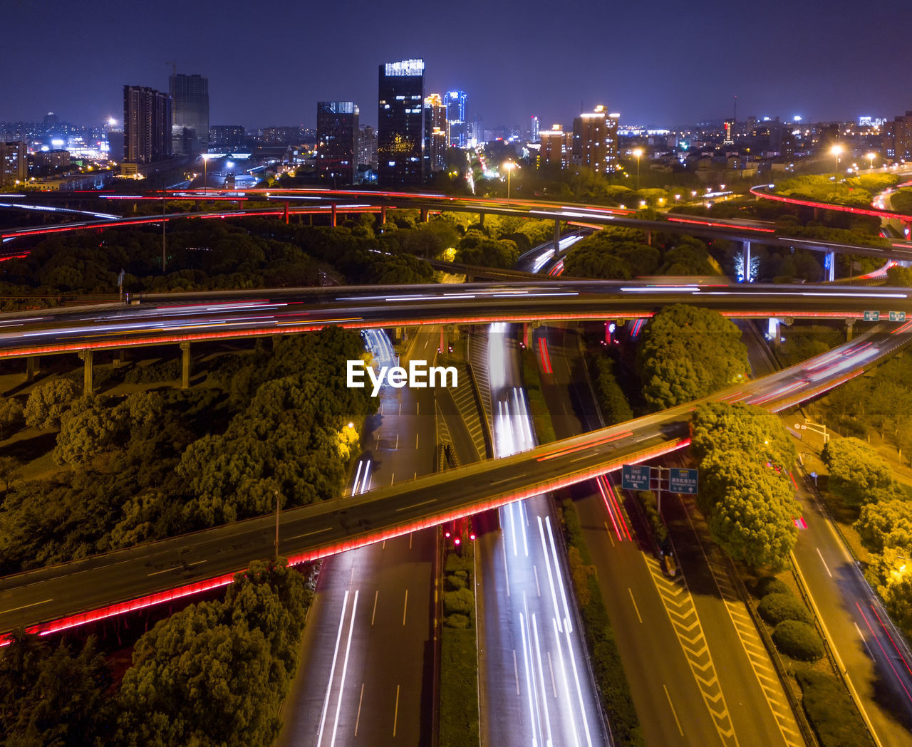 HIGH ANGLE VIEW OF LIGHT TRAILS ON CITY STREET AT NIGHT