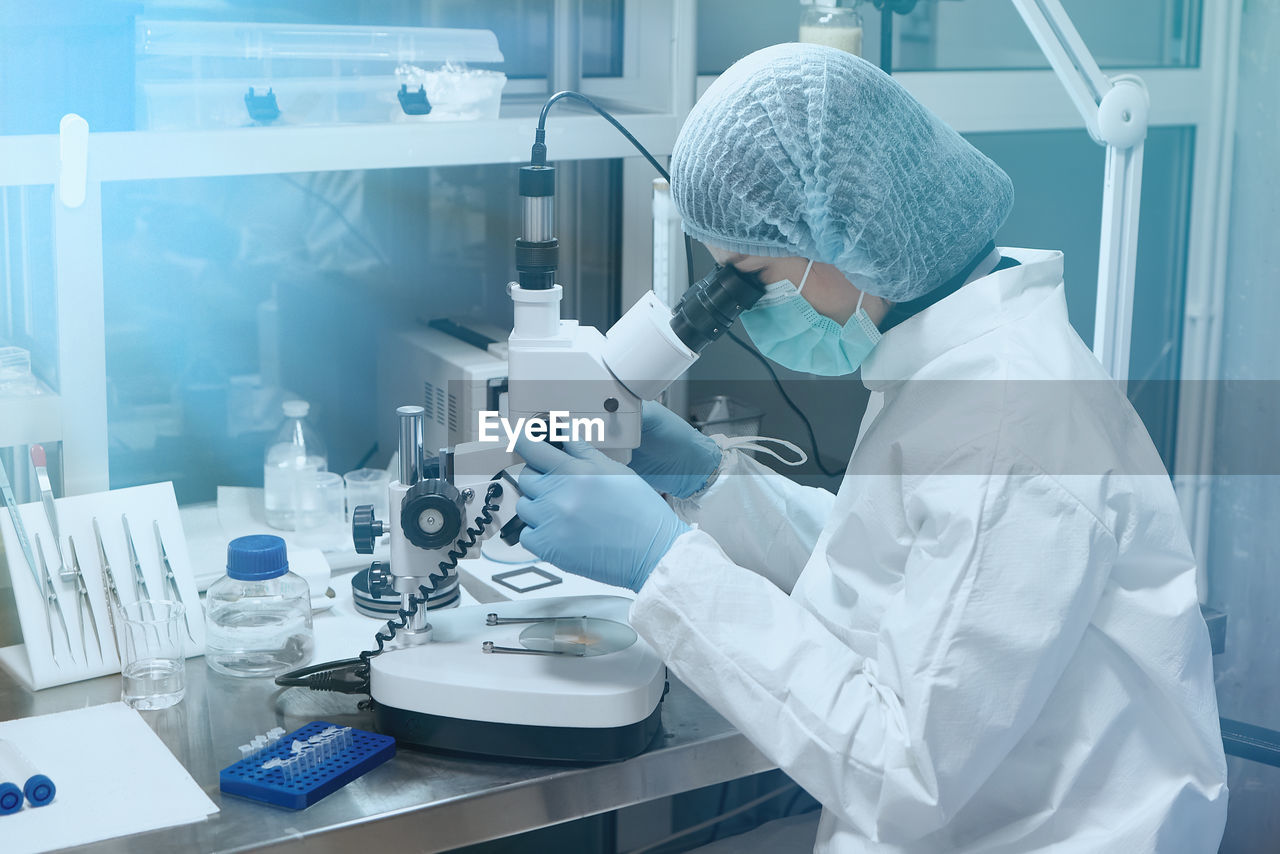 female scientist examining chemical in laboratory