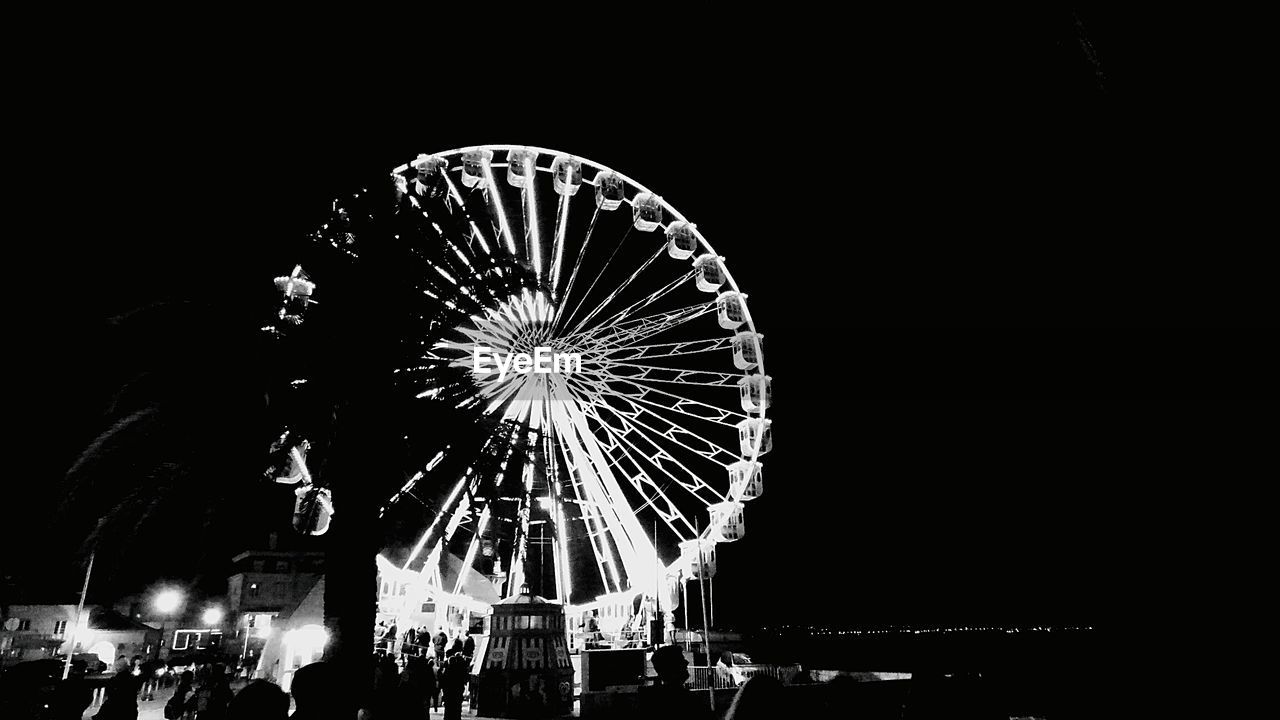 LOW ANGLE VIEW OF ILLUMINATED FERRIS WHEEL