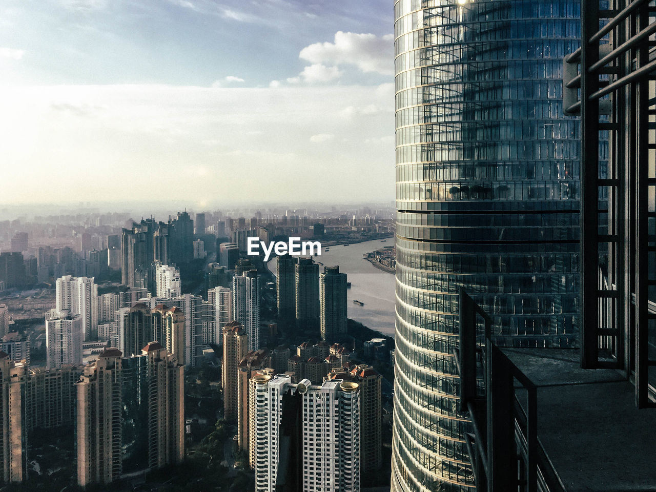 High angle view of cityscape against cloudy sky