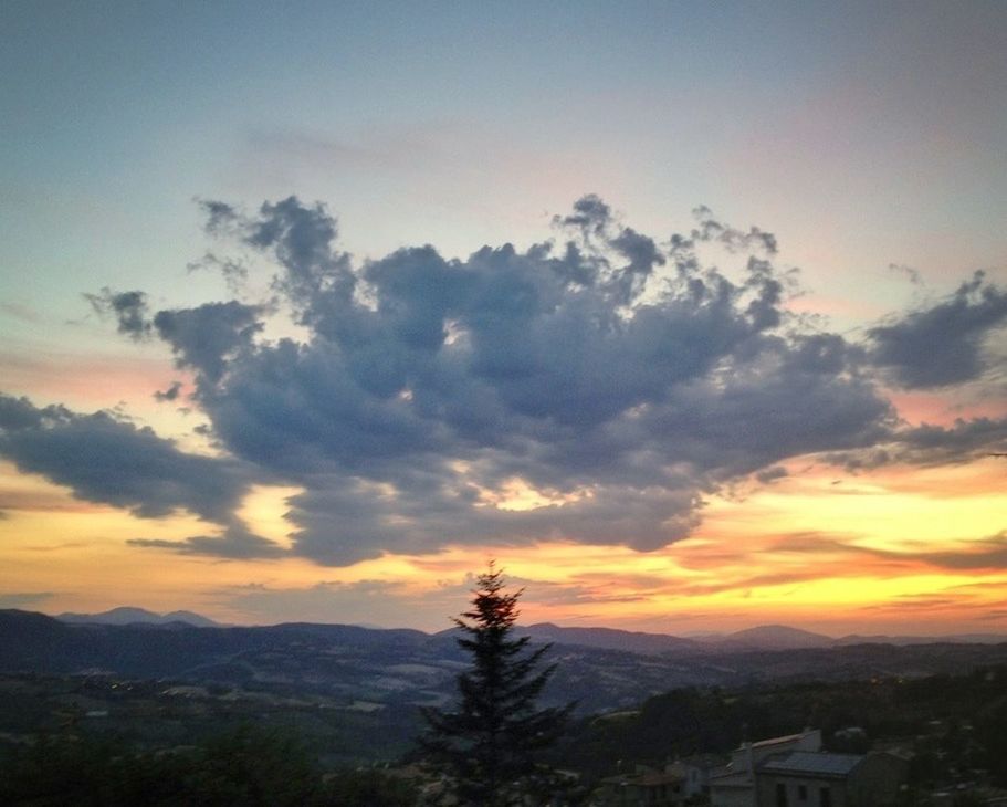 SCENIC VIEW OF MOUNTAINS AT SUNSET