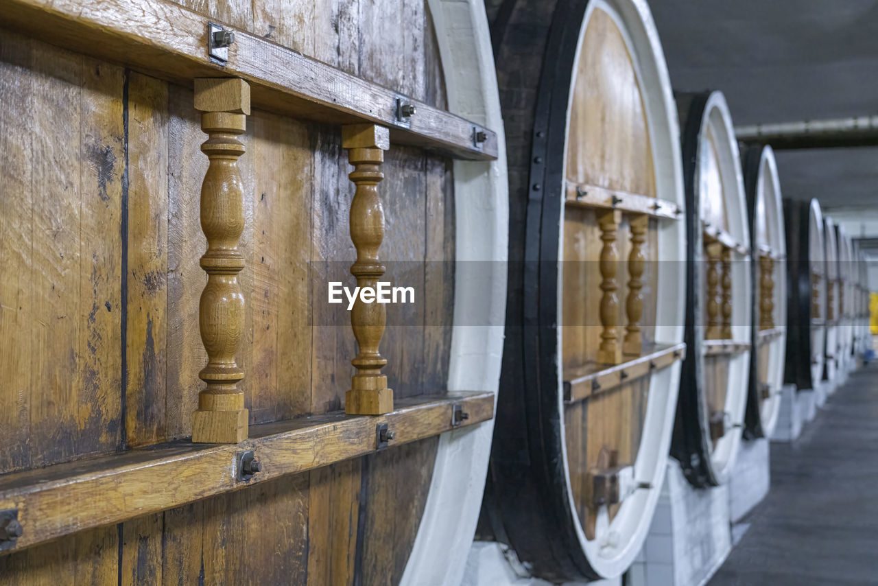 Barrels of wine in wine cellars close-up