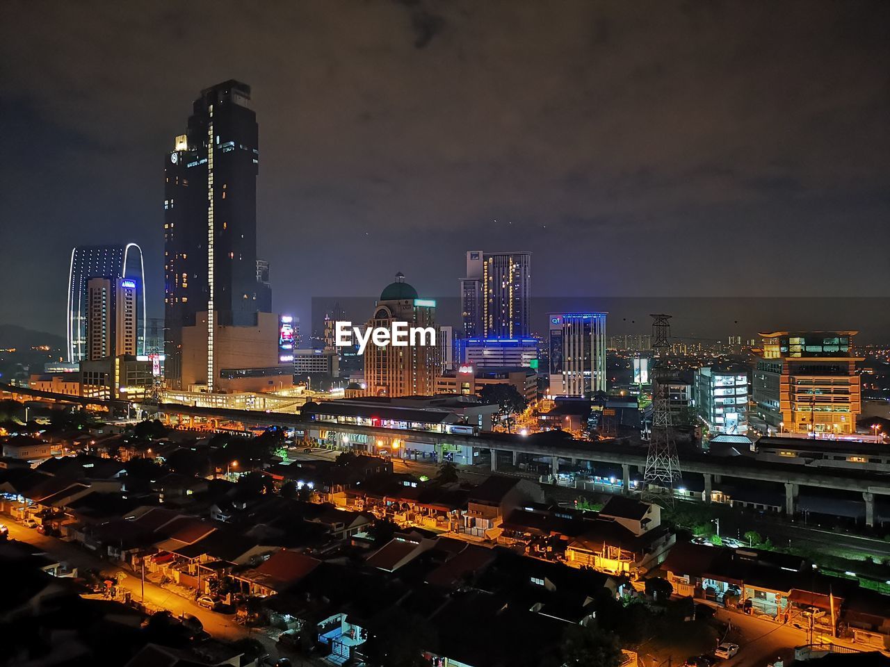 Illuminated buildings in city against sky at night