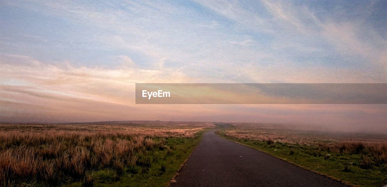 VIEW OF COUNTRY ROAD AT SUNSET