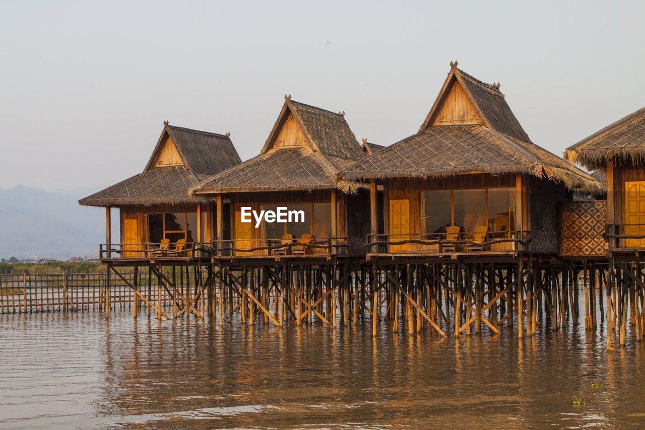 Gazebo in lake against clear sky