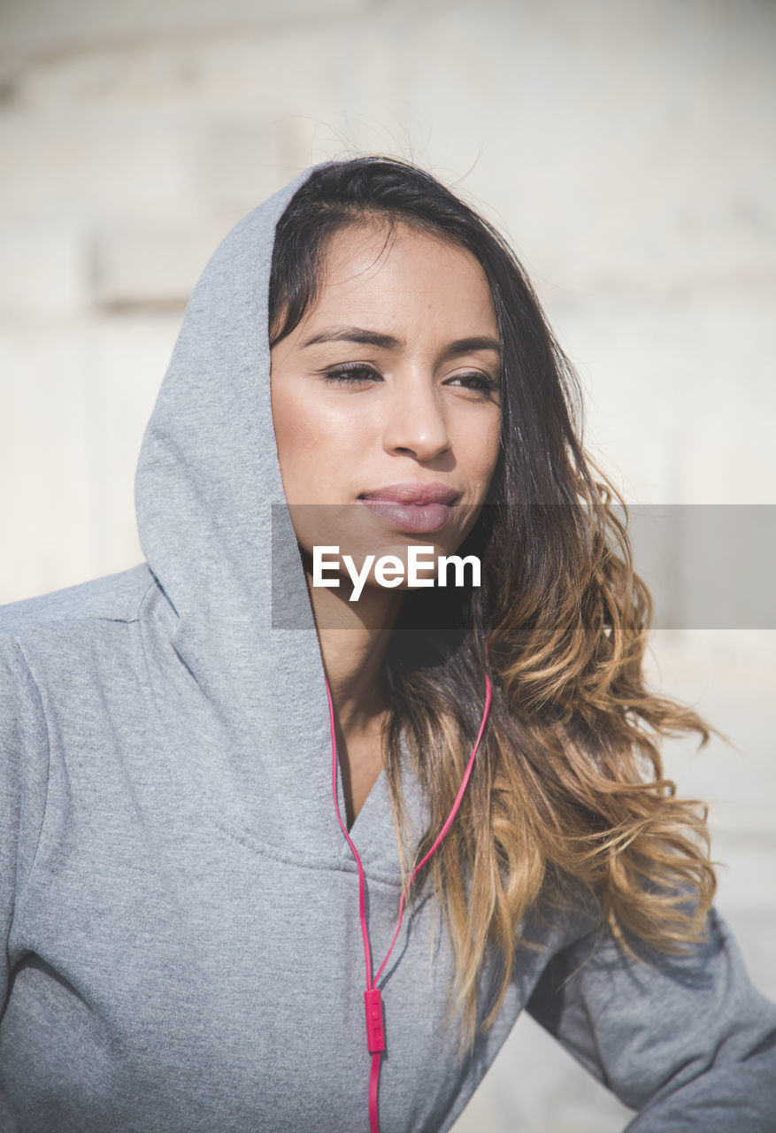 Portrait of beautiful young woman wearing hoodie