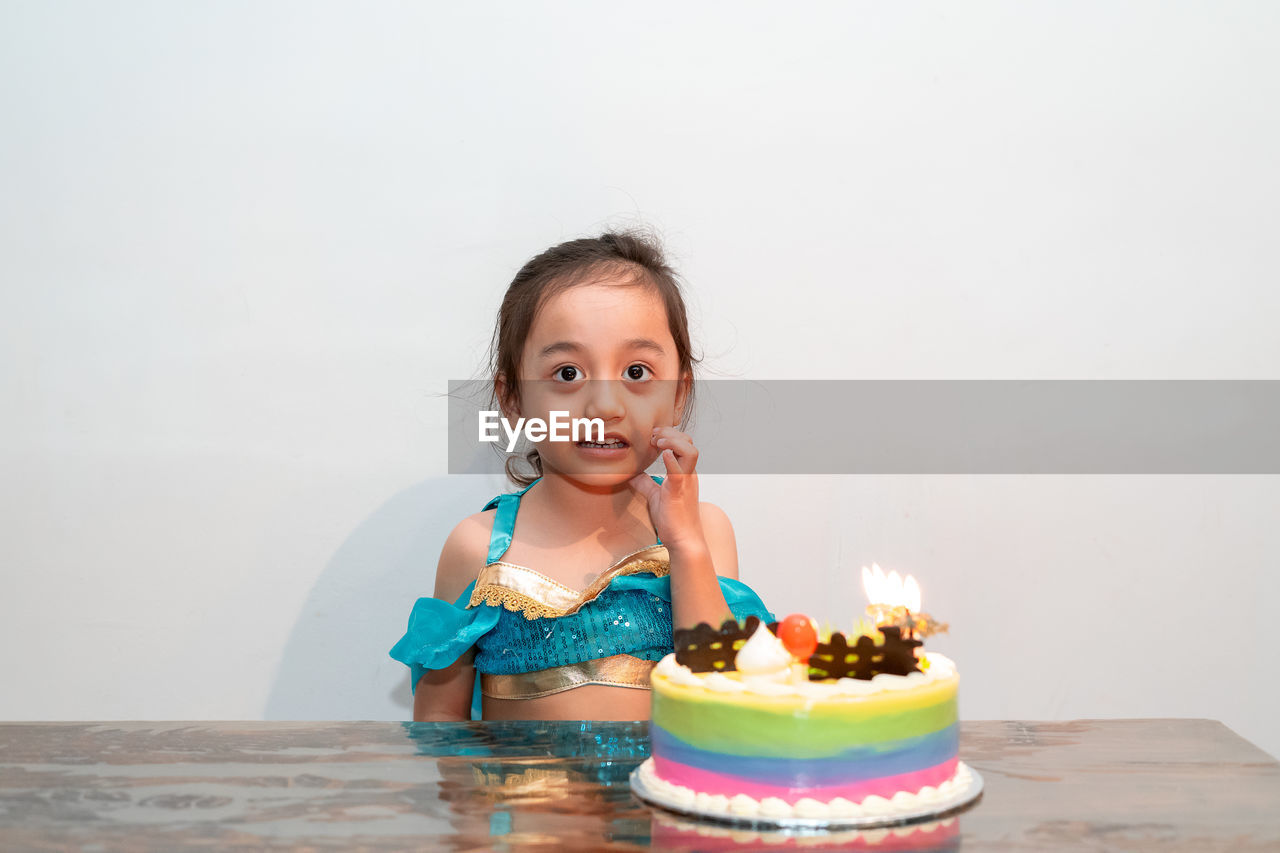 Little girl celebrating her birthday at home during quarantine. wearing arabian princess costume.