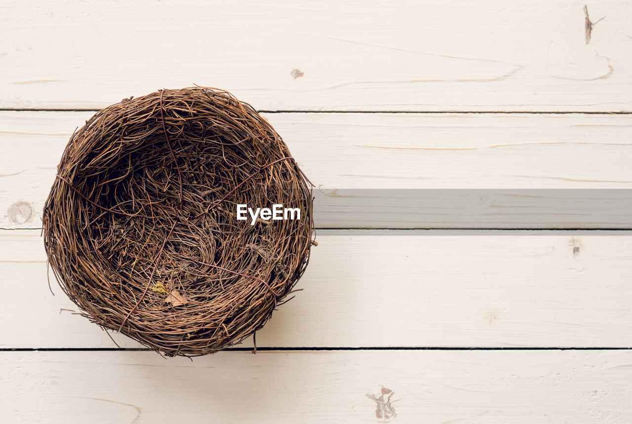 Directly above shot of empty nest on wooden table