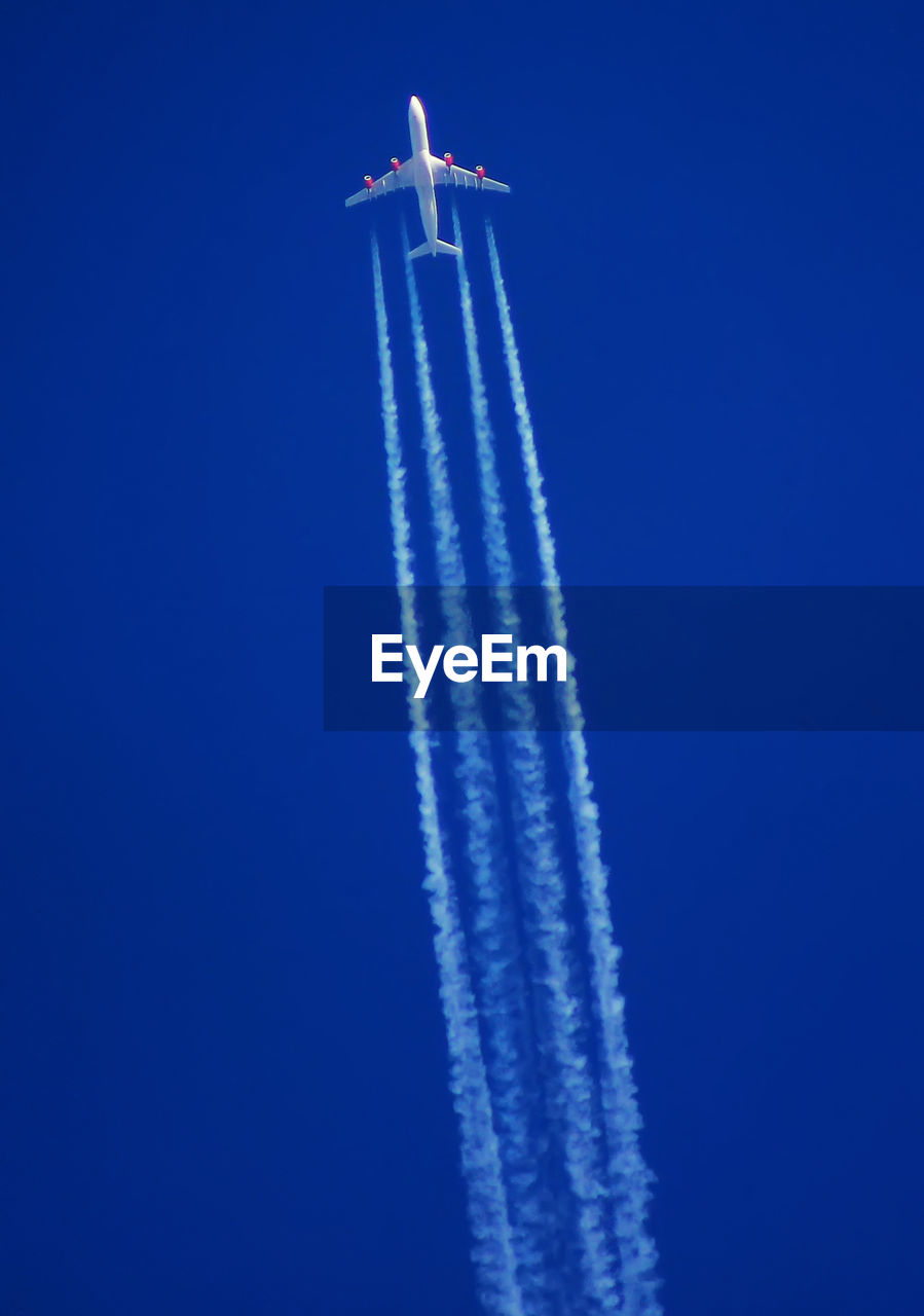 LOW ANGLE VIEW OF AIRPLANE FLYING IN SKY