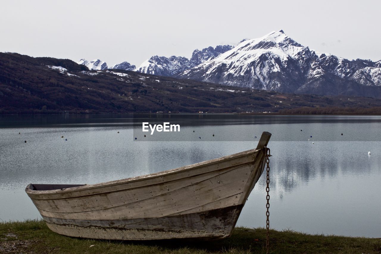 Calm lake against rocky mountains