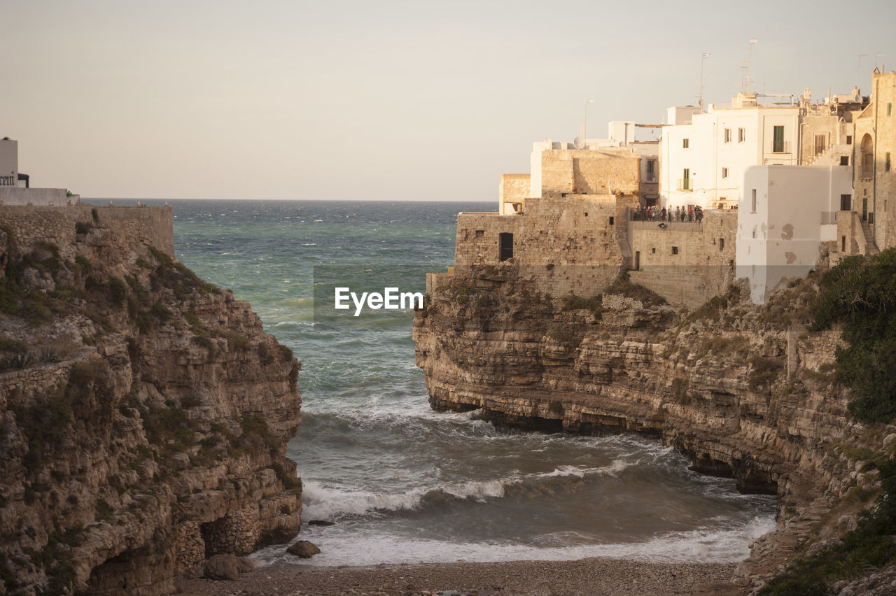 High angle view of sea and buildings against clear sky