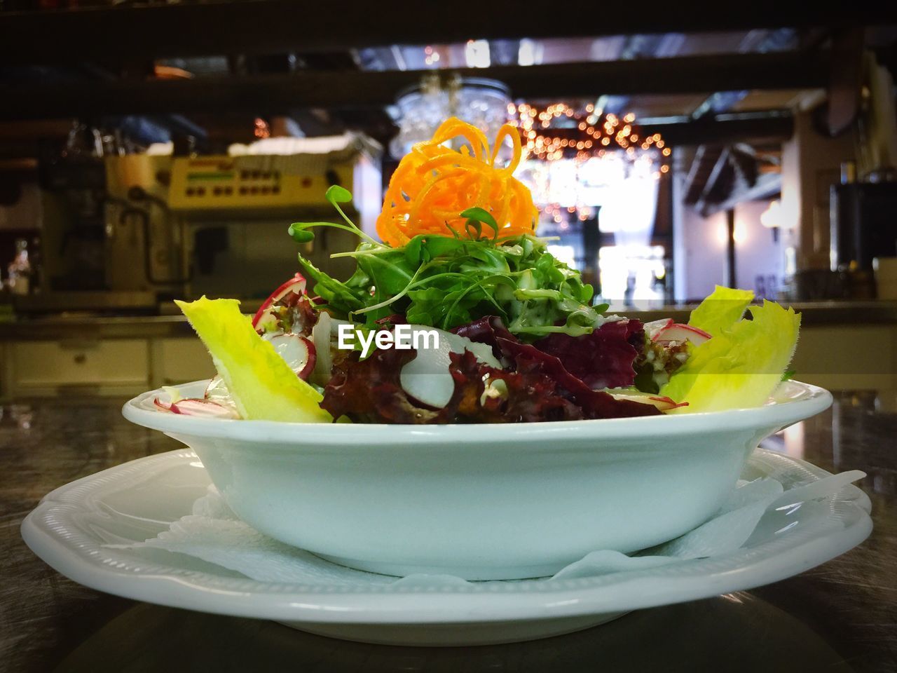 Close-up of vegetable salad bowl served on table